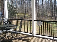 <b>View from inside a screened porch room with black aluminum balusters</b>